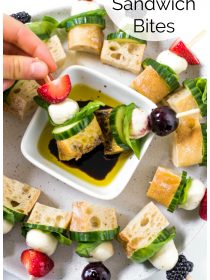 dipping a Mini Focaccia Sandwich in balsamic and oil