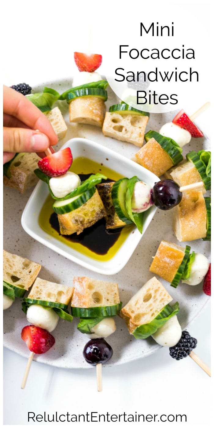 dipping a Mini Focaccia Sandwich in balsamic and oil