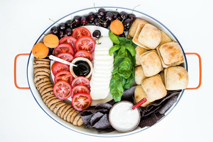 oval platter of deconstructed caprese sandwich slider ingredients