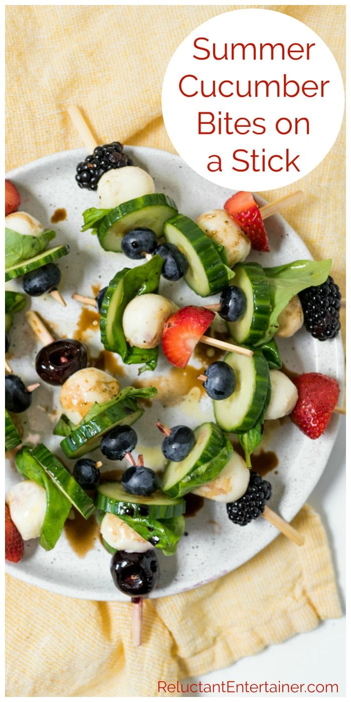 A plate of Summer Cucumber Bites on a Stick with strawberries, cherries, blackberries, and blueberries