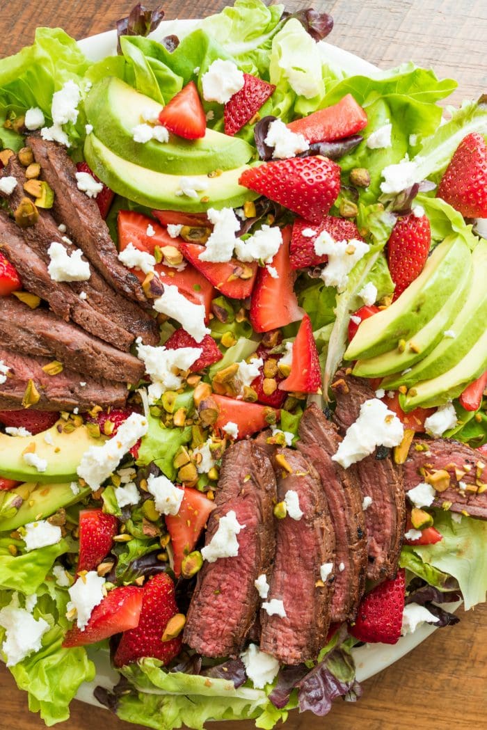 beautiful salad with marinated flank steak, strawberries, and goat cheese