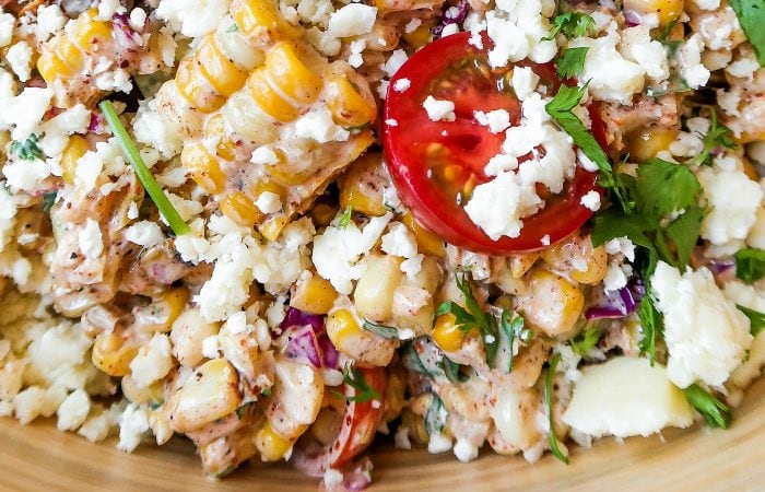 a bite of summer corn tomatoe salad (with a hunk of corn and cherry tomato)