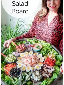 woman in red blouse holding a big red board filled with shrimp salad ingredients