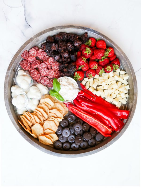 snack board with a bowl of cauliflower dip in the center