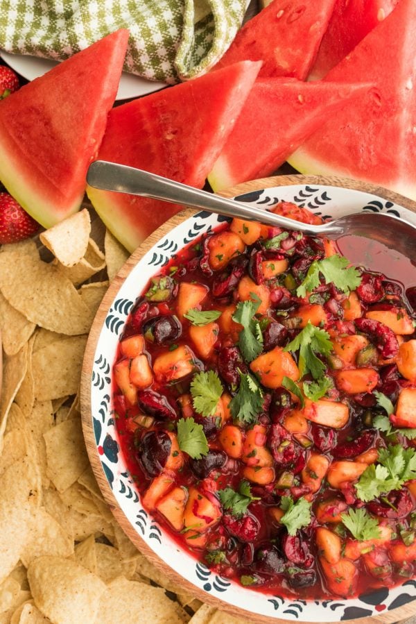 bowl of peach and cherry salsa with chips