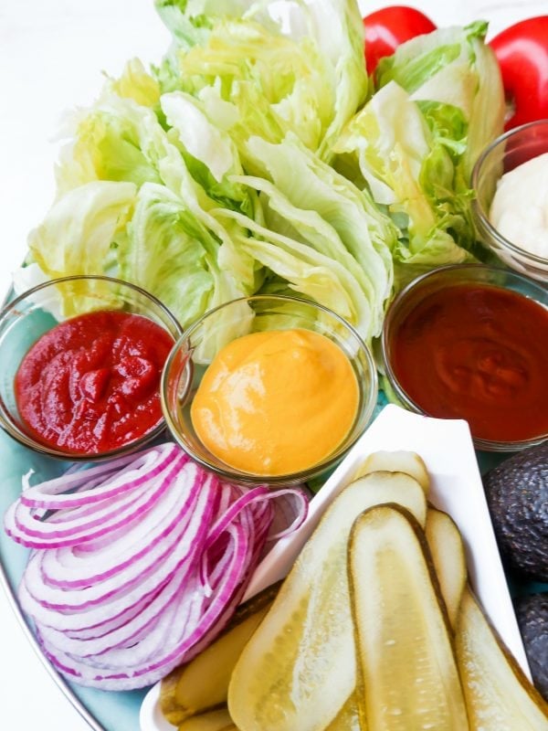 ketchup and mustard on a Basic Burger Condiment Platter, with red onion, pickles, iceberg lettuce