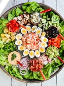 shrimp cobb salad ingredients on a big round board