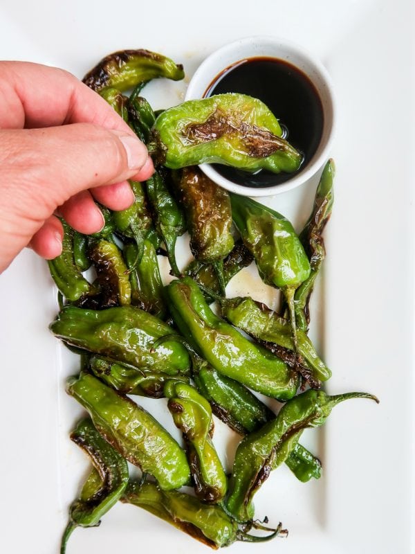 dipping a Shishito Pepper in soy sauce