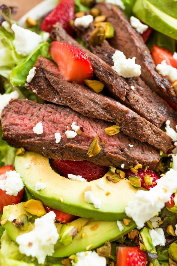 grilled steak with avocado and strawberries and pistachio nuts