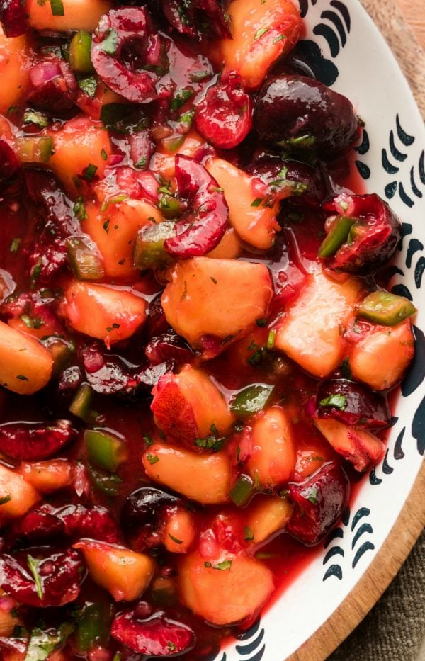 chunks of peaches and cherries in a bowl