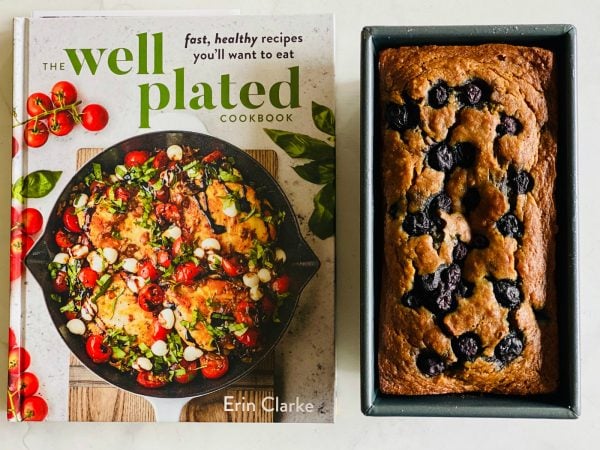 the well plated cookbook with a loaf of banana blueberry bread