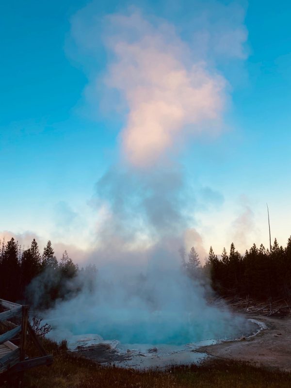 beautiful sunrise in Yellowstone National Park with geyser