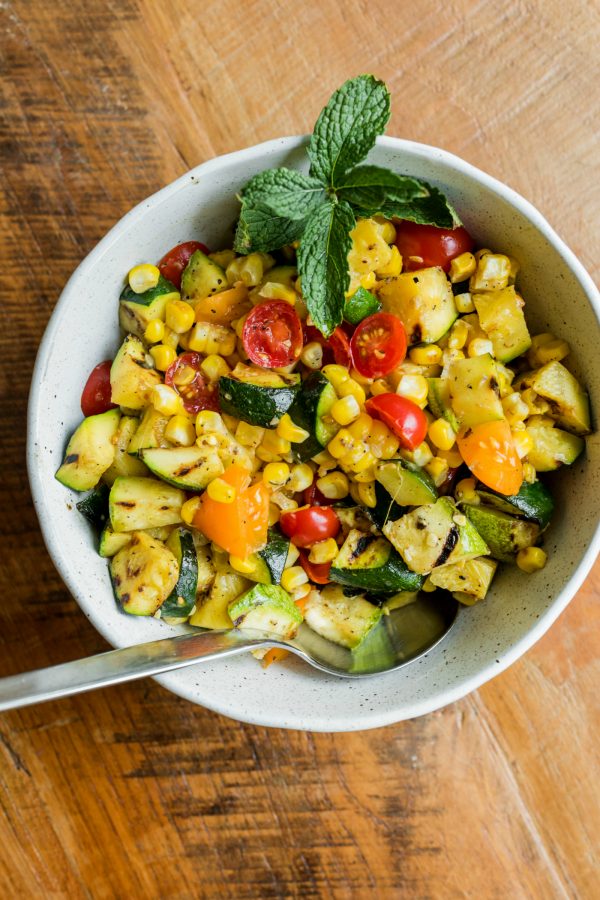 a large bowl of Grilled Zucchini, corn, and tomatoes