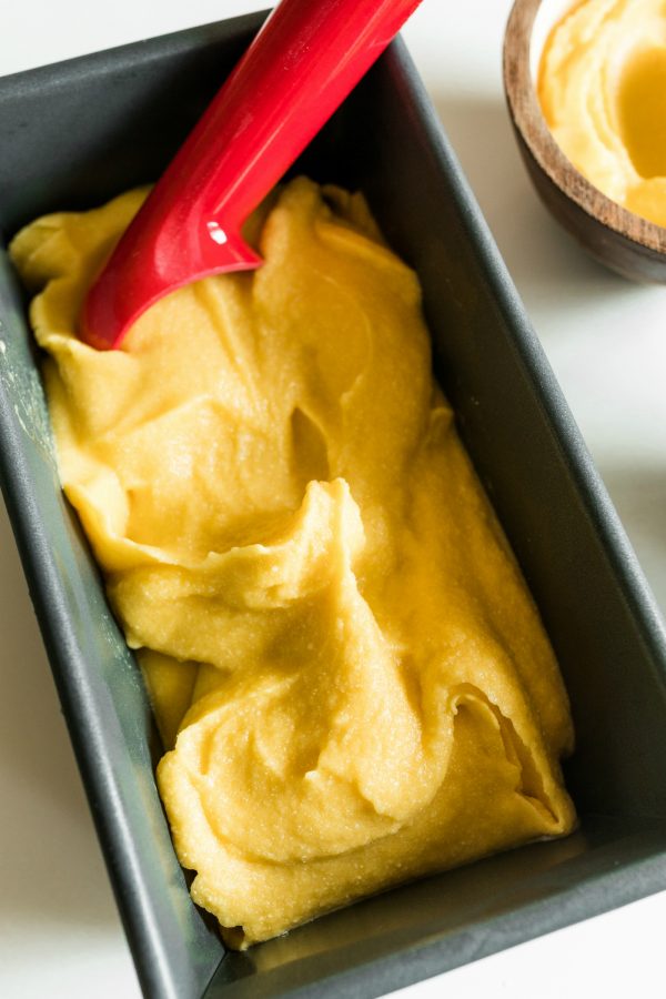 a baking loaf filled with mango sorbet dessert