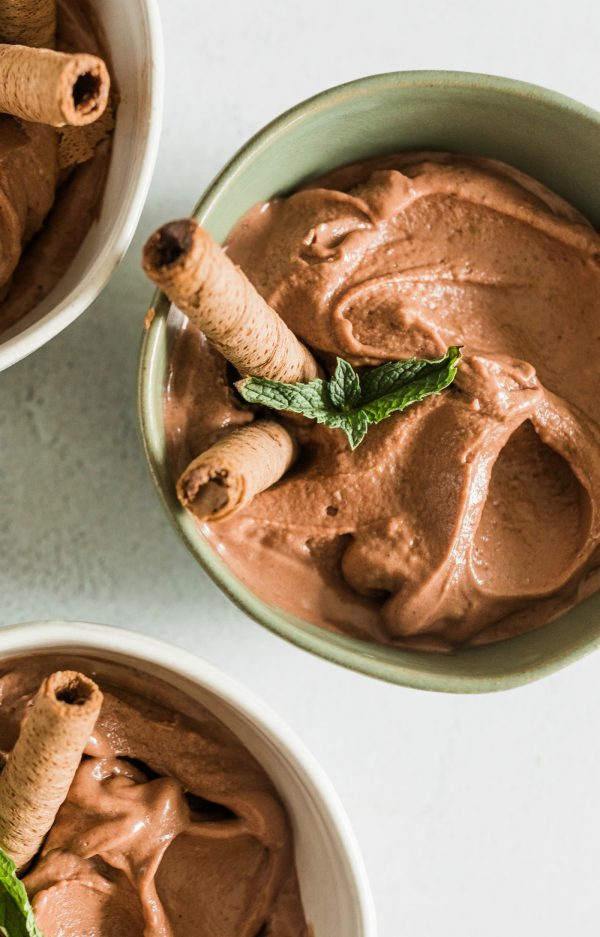 bowl of banana and chocolate peanut butter ice cream with 2 cookies