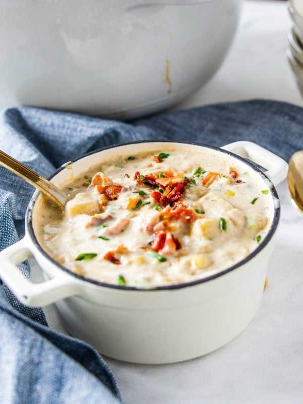 stirring a pot of best seafood chowder in white pot