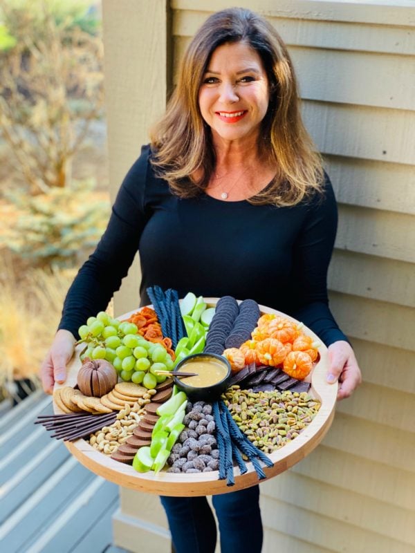 woman holding a halloween snack board