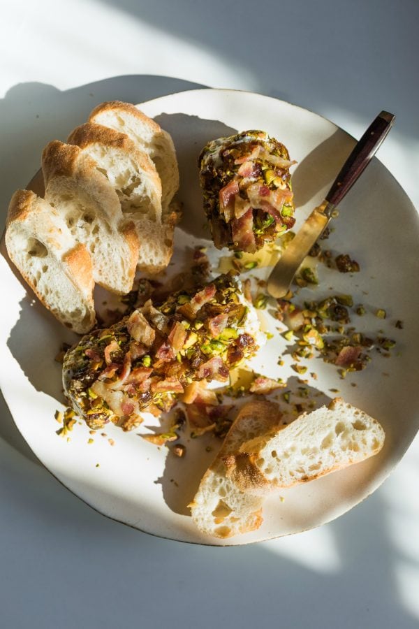 plate of Pistachio Bacon Date Cheese Logs with bread