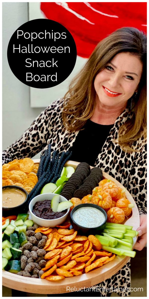 woman holding a halloween snack board