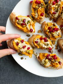 taking a bite of Sweet Potato Garlic Crostini