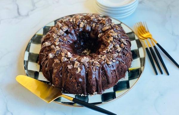 Toffee Crunch Chocolate Bundt Cake on black and white checkered plate