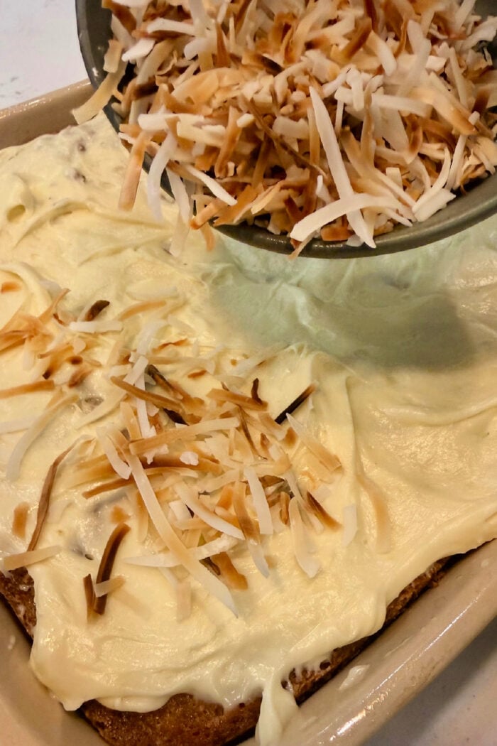 adding coconut to cake
