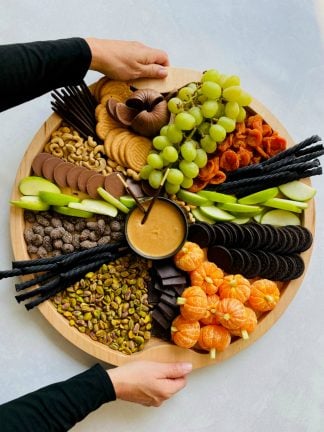 holding a halloween snack board