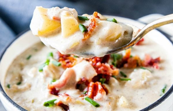 a spoonful of seafood chowder with potatoes and bacon