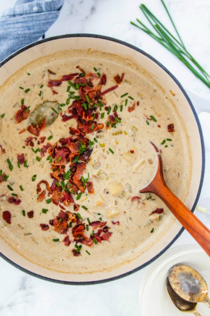 pot of seafood chowder with chives