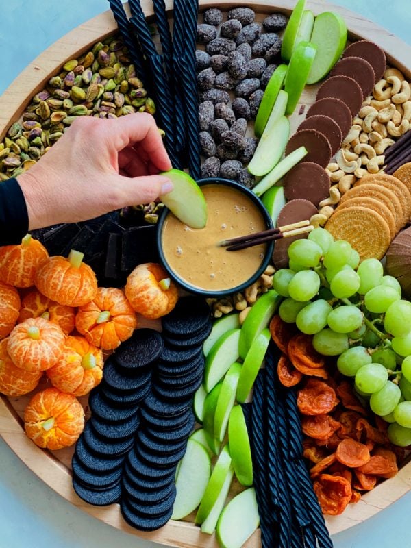 dipping halloween snacks in peanut butter