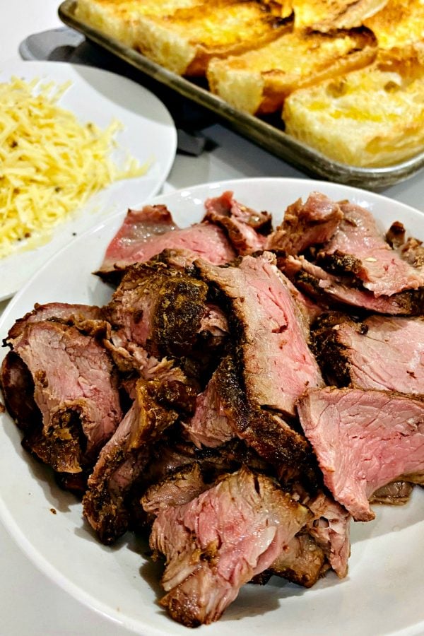 a plate of cooked, sliced steak