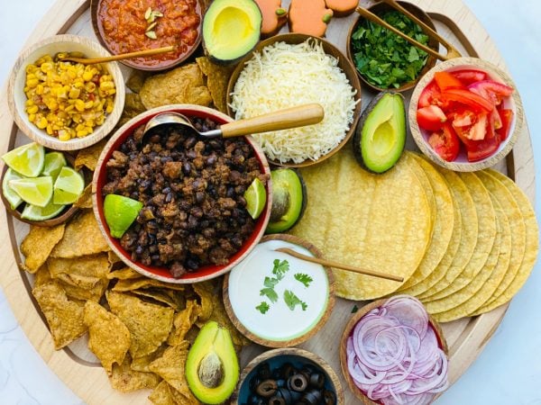 deconstructed taco ingredients on a round board
