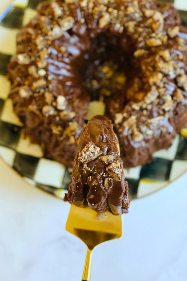 slice of Toffee Crunch Chocolate Bundt Cake on a gold server