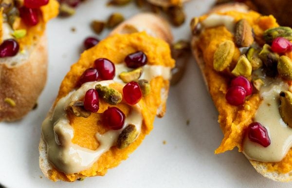 a delicous Sweet Potato Garlic Crostini with pomegranate seeds