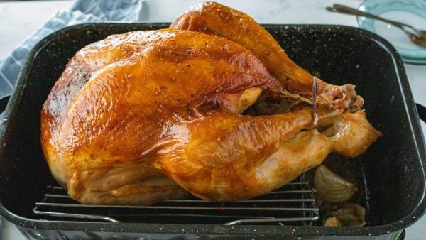 a whole bird (Apple Cider-Brined Turkey) in baking pan