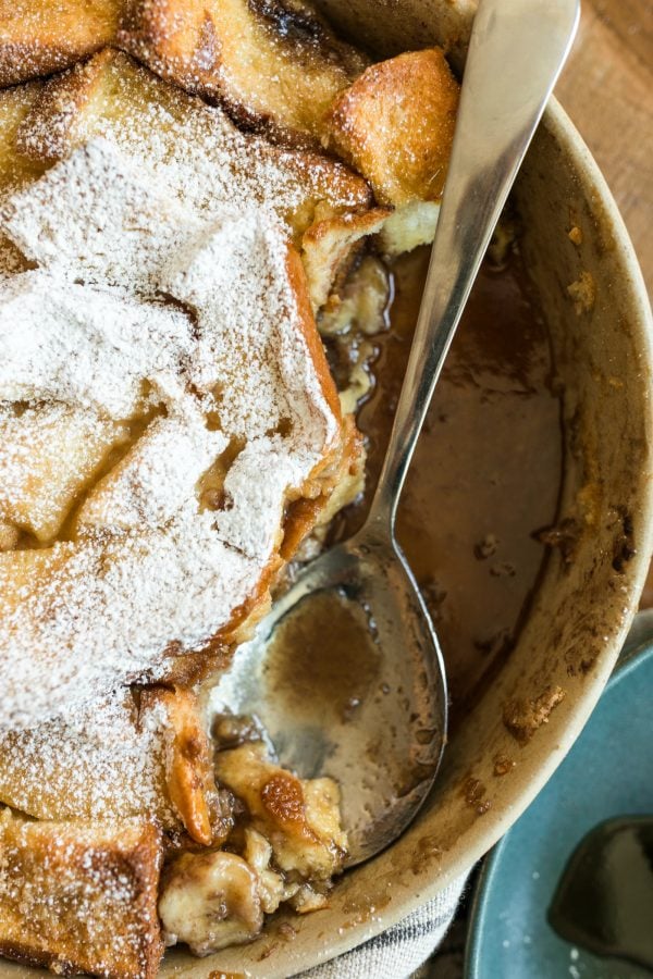 pan of Banana Bread Brioche French Toast with a large spoon