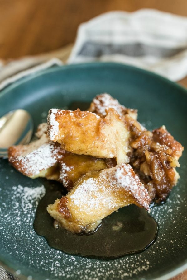 serving of Banana Bread Brioche French Toast sprinkled with powdered sugar