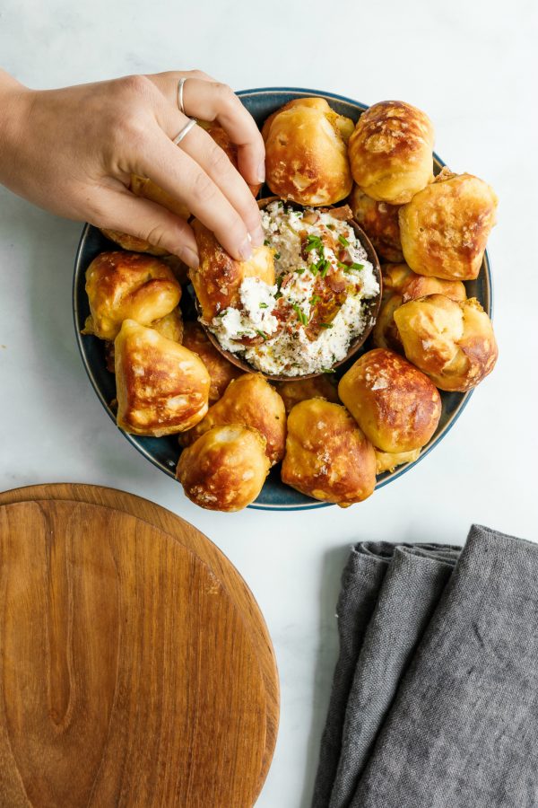 dipping pretzel bite made with biscuits in a dip