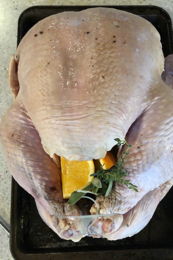 stuffing a turkey with citrus and herbs