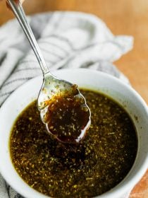 white bowl of Lemon Balsamic Dressing with a spoon