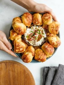 serving a Biscuit Pretzels appetizer with dip in the center