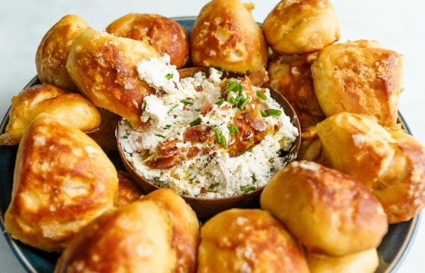 dipping homemade biscuit pretzels in dip