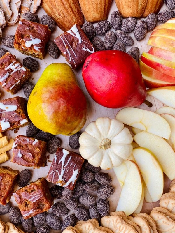 pears and pumpkins as a garnish on a round sweet snack board