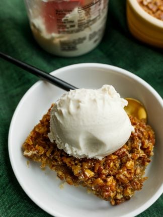 serving of pecan bars on a plate with scoop of ice cream