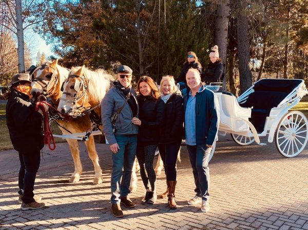 4 people getting ready to go on sleigh ride