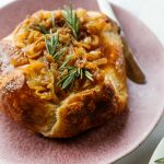 Onion Brie En Croute with knife on serving plate