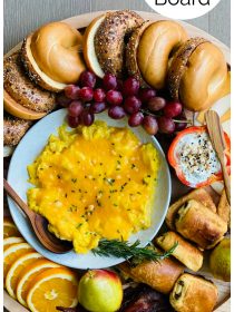 an bagel board with eggs, meat, cheese