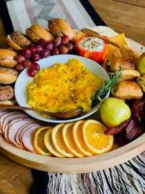 round wood board with breakfast bagel foods