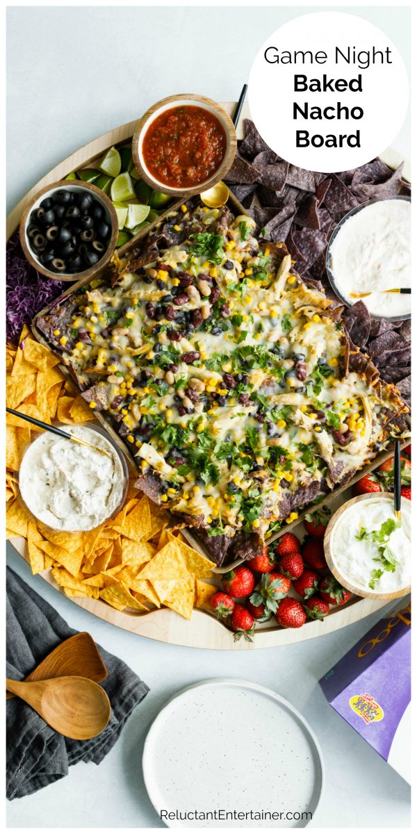 a nacho board with chips and dips and taboo game