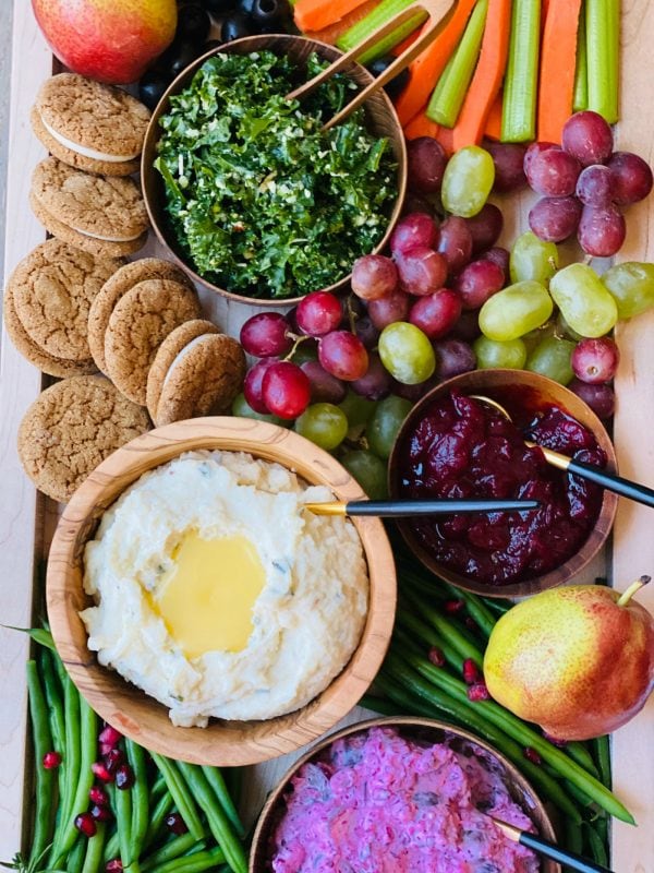 mashed potatoes, kale salad, grapes on dinner board